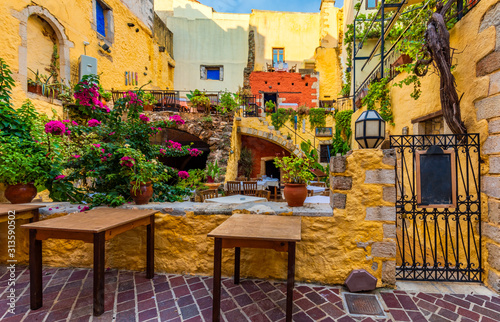 Fototapeta Naklejka Na Ścianę i Meble -  Street in the old town of Chania, Crete, Greece. Charming streets of Greek islands, Crete. Beautiful street in Chania, Crete island, Greece. Summer landscape. Chania old street of Crete island Greece.