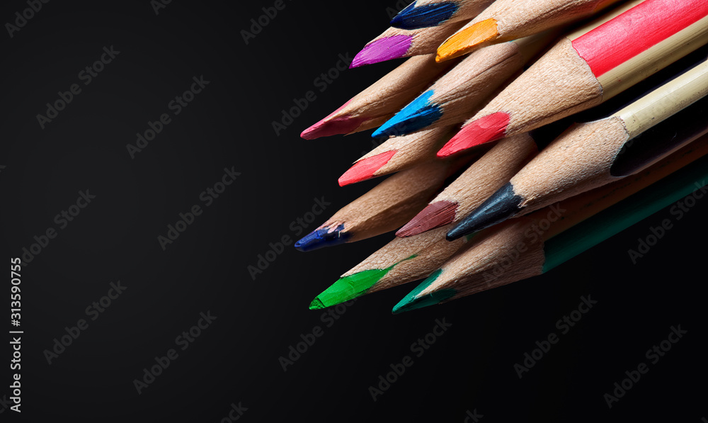 color pencils over black background with copy space color pencils over black background with copy space
