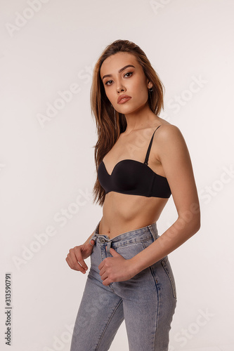 Premium Photo  Portrait of sexy smiling asian woman with long hair posing  in black lingerie, blue jeans. skinny girl in bra