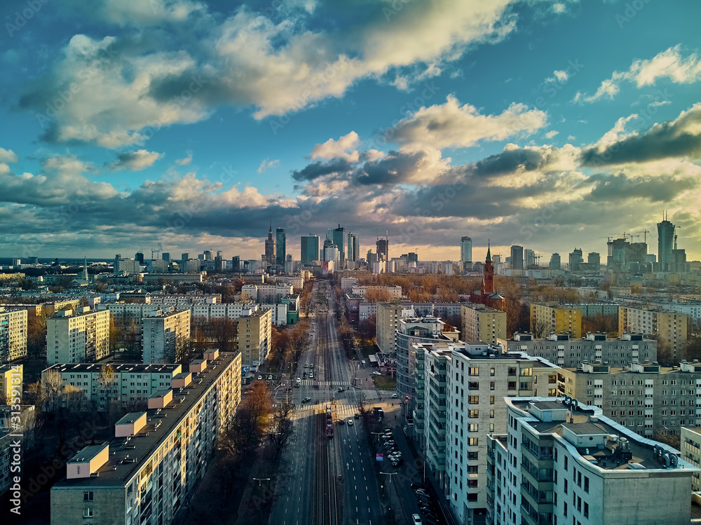 Obraz Beautiful panoramic aerial drone view to the Сenter of modern Warsaw city with silhouettes of skyscrapers in in the rays of the setting winter January sun - amazing sunset, Poland