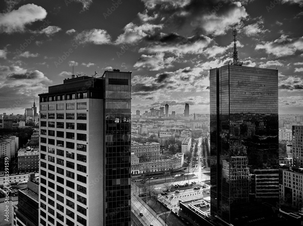 Obraz premium Beautiful panoramic aerial drone view to the Сenter of modern Warsaw city with silhouettes of skyscrapers in in the rays of the setting winter January sun - amazing sunset, Poland
