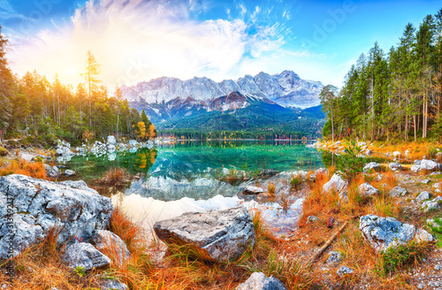 Faboulus autumn landscape of Eibsee Lake in front of Zugspitze summit under sunlight photo