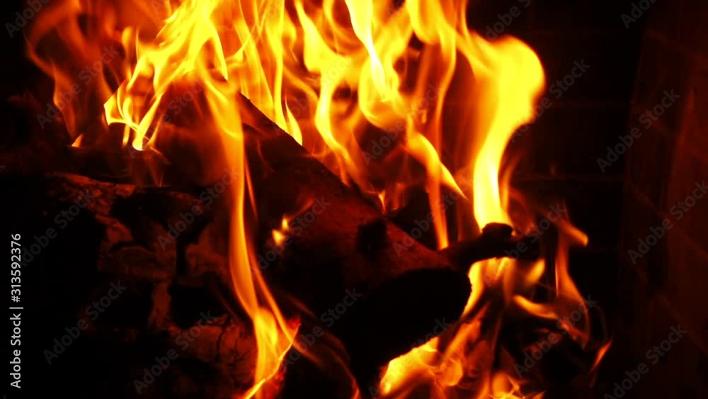 Slow motion video of cosy fireplace with reddish flame burning during winter holidays Slow motion video of cosy fireplace with reddish flame burning during winter holidays