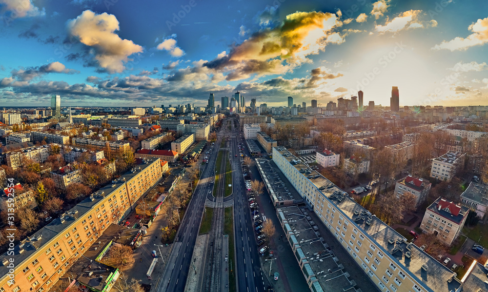 Obraz Beautiful panoramic aerial drone view to the Сenter of modern Warsaw city with silhouettes of skyscrapers in in the rays of the setting winter January sun - amazing sunset, Poland