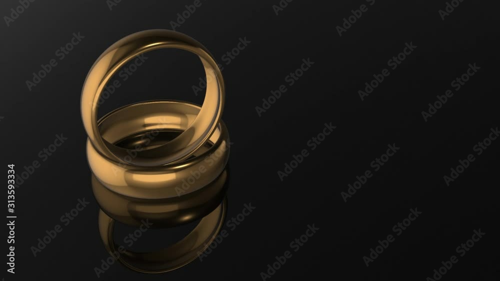 3D rendering.Two gold wedding rings on black background, loopable 3D rendering.Two gold wedding rings on black background, loopable