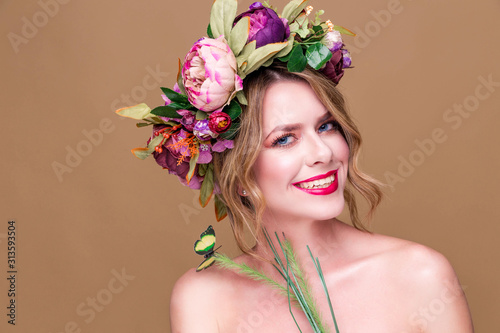 tender young woman posing in flower wreath with artificial greenbutterfly, isolated on ochet background