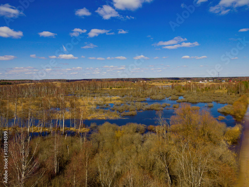 Spring flood on the river near the village from a bird s eye view.