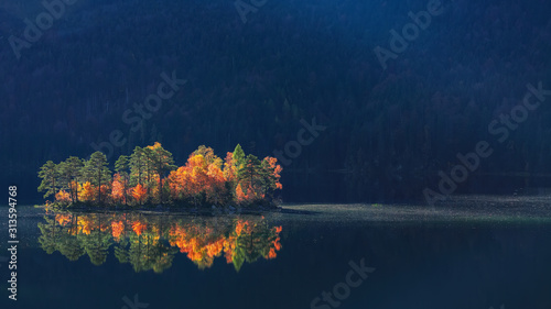 Charming autumn landscape of islands with pine-trees in the middle of Eibsee lake.