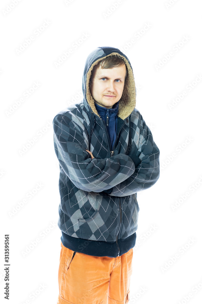 a young man in a jacket and orange pants looks at the camera. Isolated