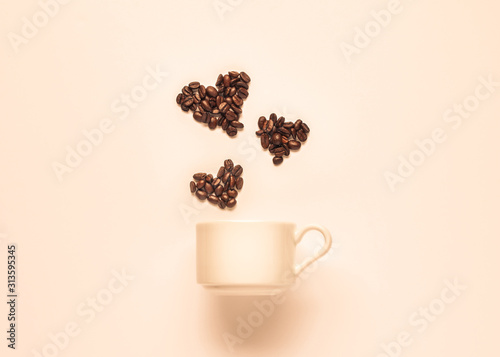 Love for coffee concept. Coffee cup and hearts made from coffee beans tinted in beige shades.