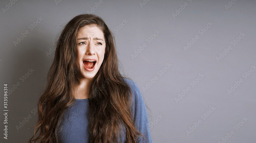 young woman screaming or shouting with her mouth wide open young woman screaming or shouting with her mouth wide open