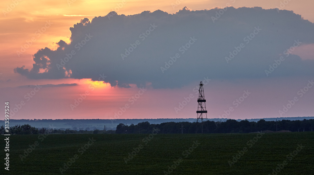 Gas production, oil production. Drilling rig against the setting sun Gas production, oil production. Drilling rig against the setting sun