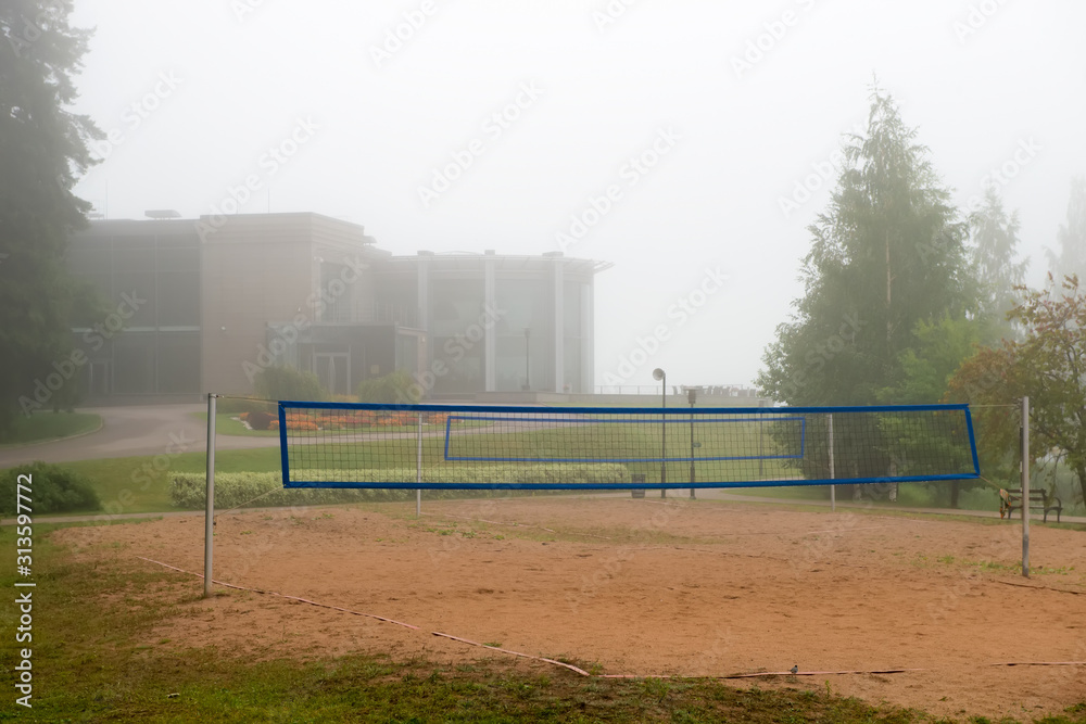 Sports volleyball court on an early foggy morning. Sports volleyball court on an early foggy morning.