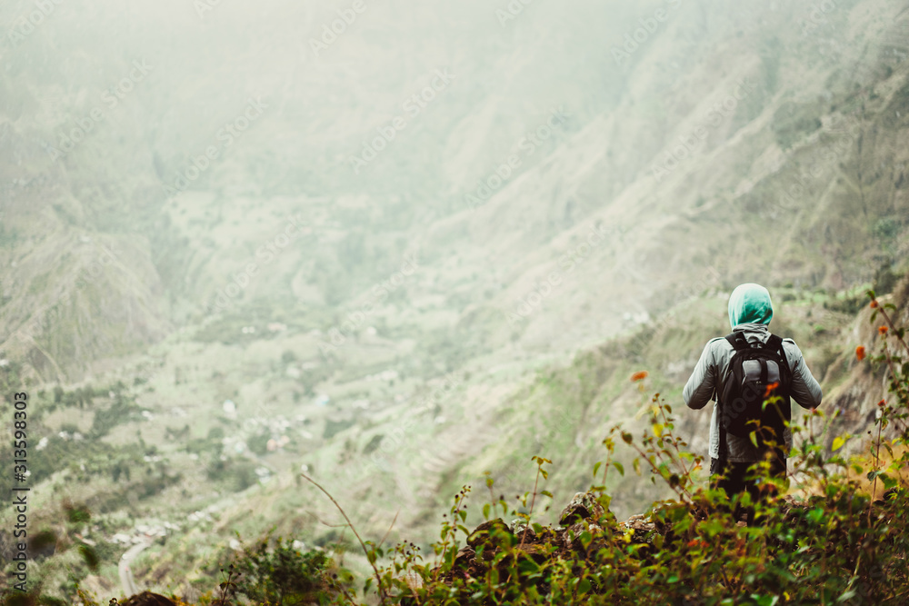 Man tourist with backpack enjoying valley rural landscape on hike path at Santo Antao Island, Cape Verde