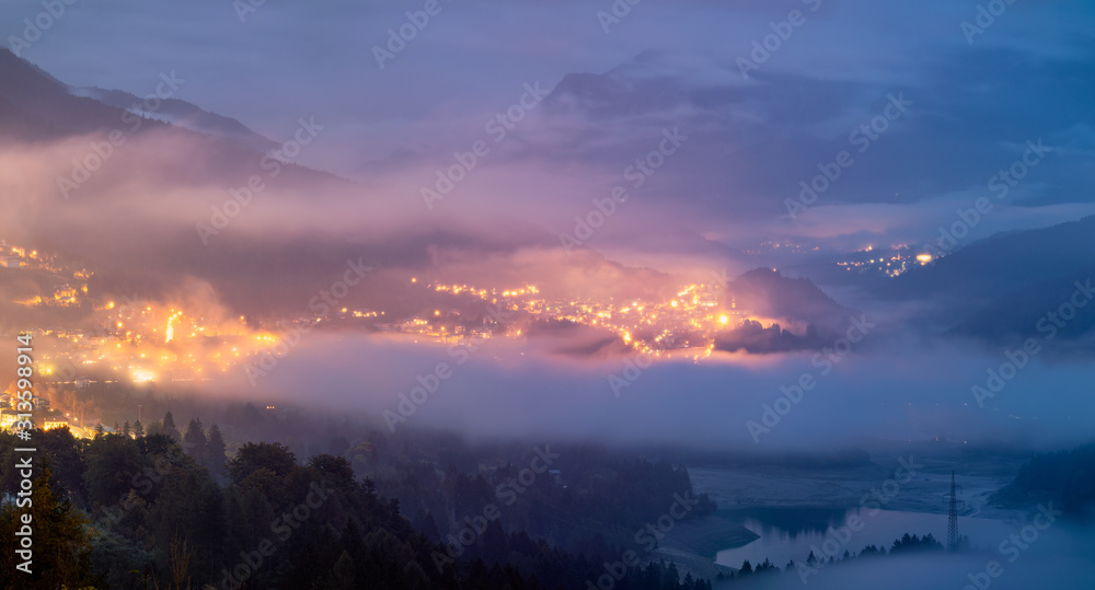 Fototapeta premium Panoramic view of lake of Centro Cadore in the Alps in Italy, Dolomites, near Belluno. View of Lake Calalzo, Belluno, Italy. Lake of Centro Cadore in the Alps in Italy, near Belluno.