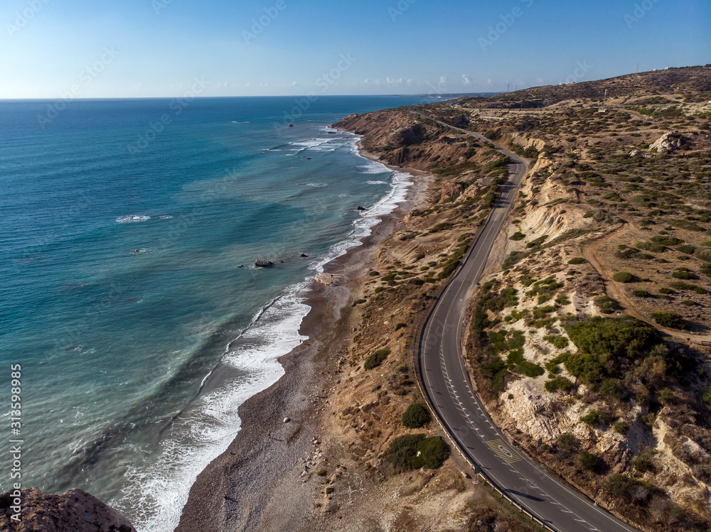 Aerial view of road going along the mountain and ocean or sea. Drone photography from above