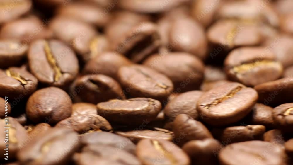 Black coffee beans revolve around the camera. Roasted coffee beans revolve around the camera. Black coffee beans revolve around the camera. Roasted coffee beans revolve around the camera.