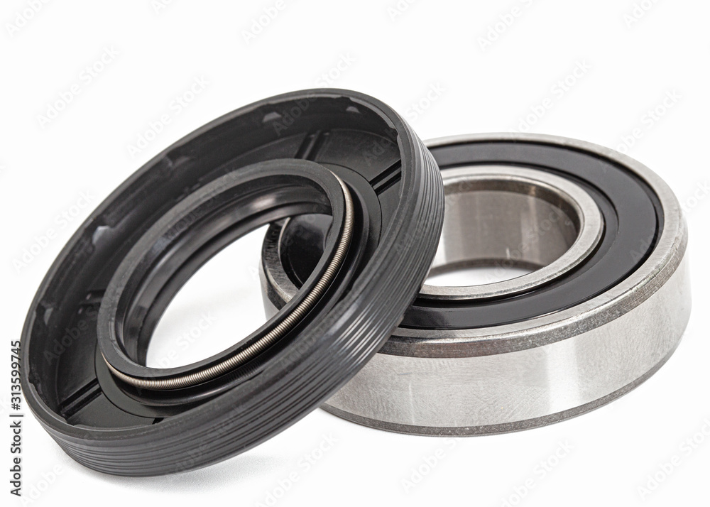 Ball bearing and oil seal for machine repair, isolated on white background Ball bearing and oil seal for machine repair, isolated on white background