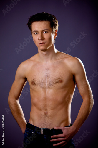 Topless man posing standing and looking at camera