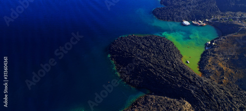 Aerial drone ultra wide photo of famous volcanic crater of Palaia Kameni with green sea in centre of Santorini island, Cyclades, Greece photo