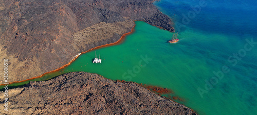 Aerial drone ultra wide photo of famous volcanic crater of Palaia Kameni with green sea in centre of Santorini island, Cyclades, Greece photo