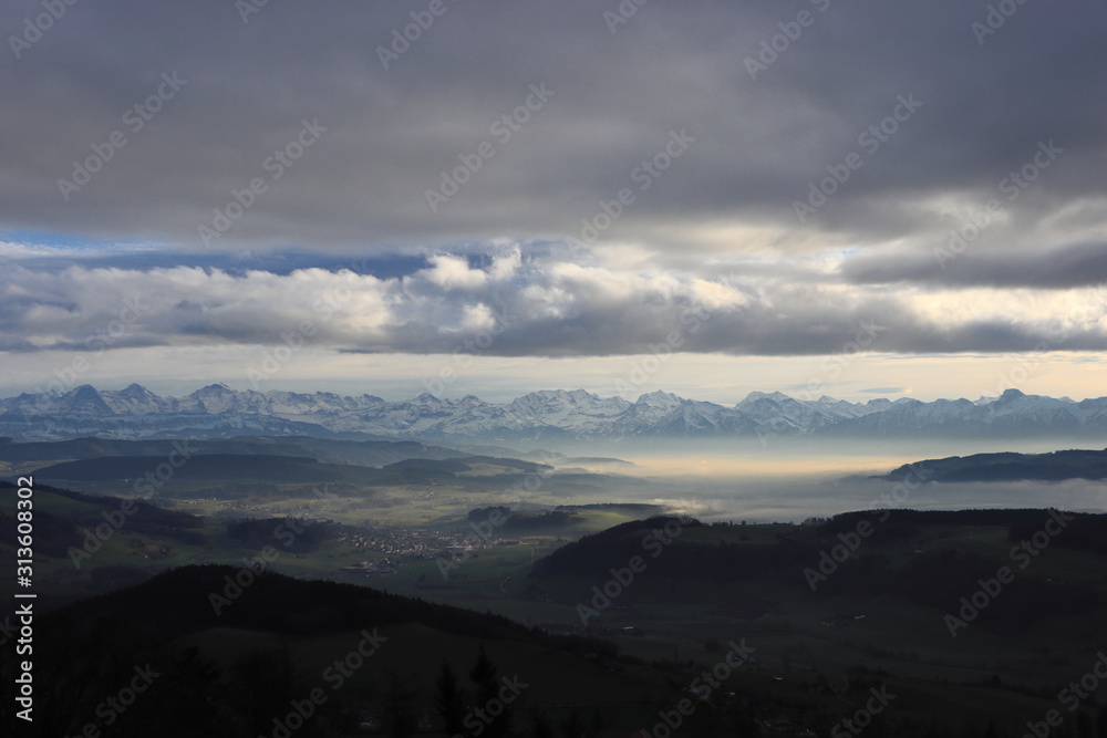 Valley south of Bern in the fog. Swiss alps in the background.