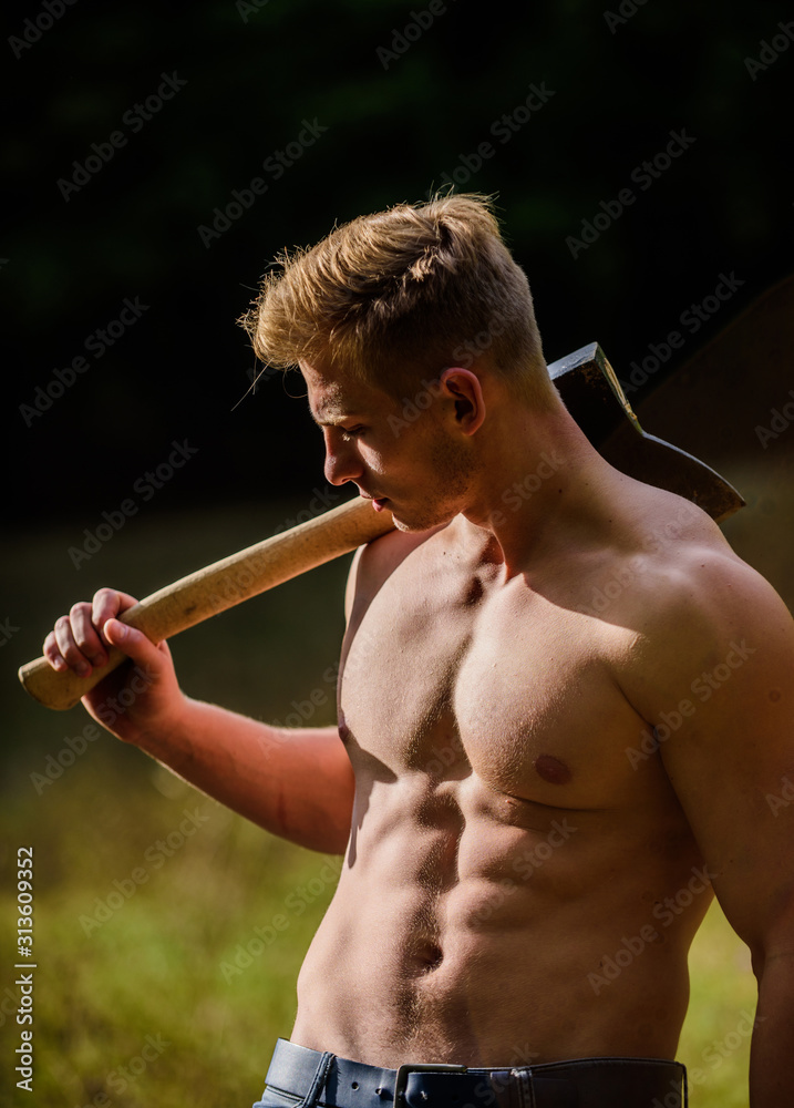 Having a little break. muscular man with axe. sexy macho bare belly ax.  bodybuilding. Lumberjack woodman sexy naked athletic torso. Masculine  concept. Illegal logging. woodsman with axe in hand Stock Photo