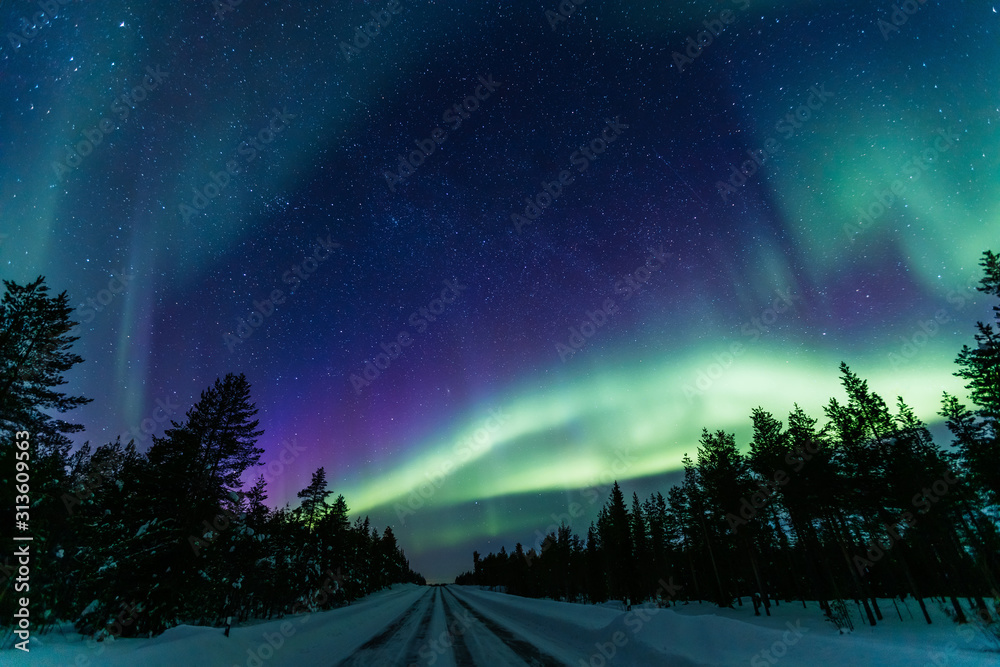 Northern lights Aurora Borealis activity over the road in Finland, Lapland Northern lights Aurora Borealis activity over the road in Finland, Lapland