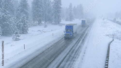 Trucks haul containers across the state of Washington and through a snowstorm.