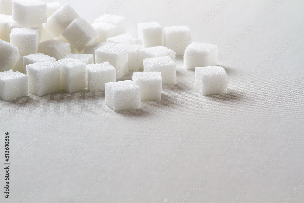 high key Closeup of a Pile of sugar cubes randomly arranged on a white background