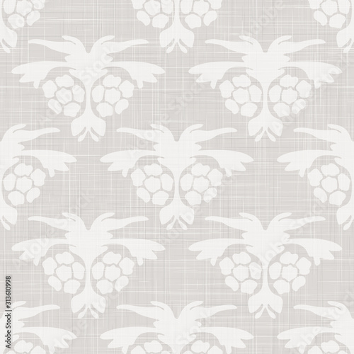 Gray french linen texture background printed with white floral motif. Natural ecru antique medallion seamless pattern. Woven foulard paisley in farmhouse country style. Vintage damask textile decor.