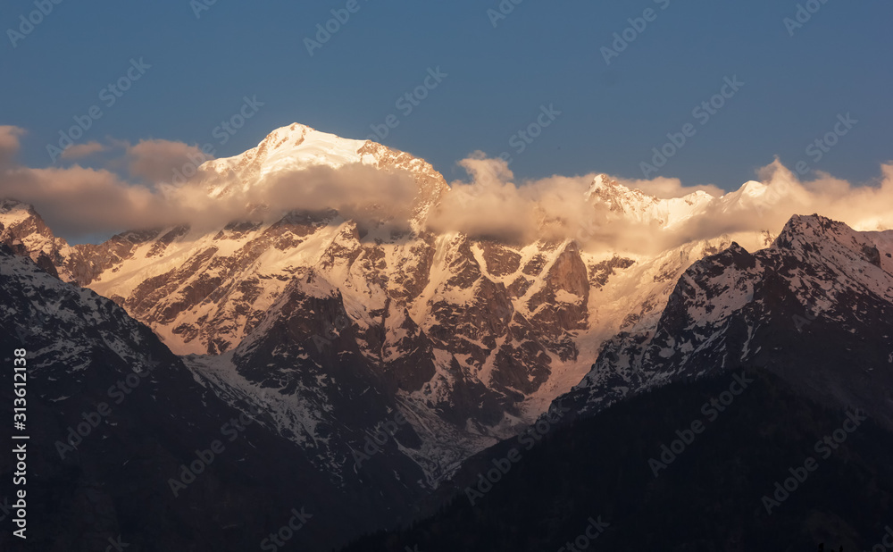 The snow covered peaks of the Kinner Kailash range in the village of Kalpa in Kinnaur in the Indian Himalaya.