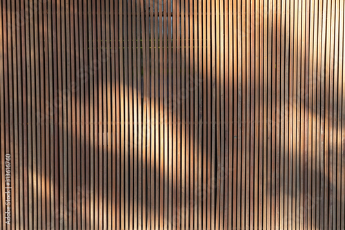 Quadro su tela light and shadows on outdoor wooden battens background and texture