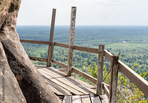 View of a wooden walkway that stretches along the cliffs of Jetiyakiri Temple (Phu Thok Temple) in Bueng Kan Province.