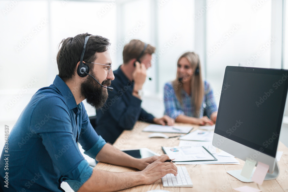 business man in a headset sitting at the office table