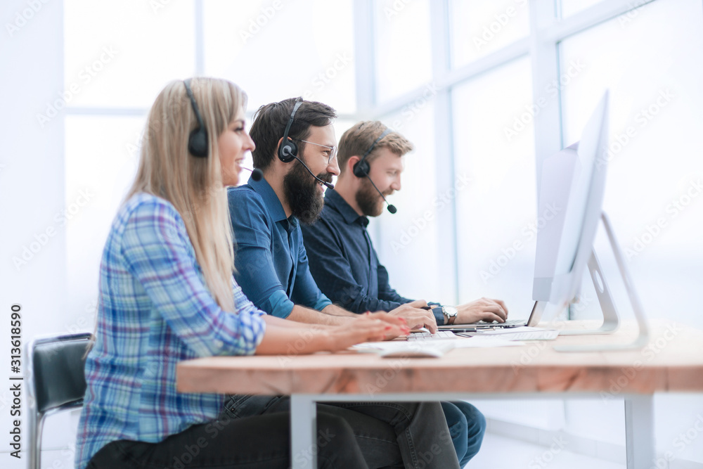 Fototapeta premium group of call center employees working on modern computers