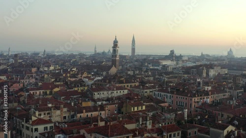 Aerial, drone shot towards the Chiesa Cattolica Parrocchiale dei Santi Apostoli, on a sunny evening, in Venice city, Italy photo