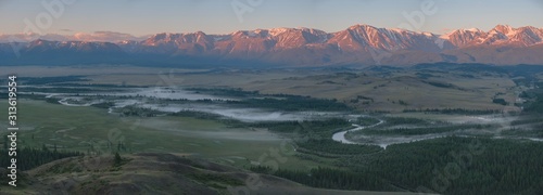 Morning fog on the river, Chuy valley in the summer. Sunrise over the North Chuysky ridge. Mountain Altai, panorama.
