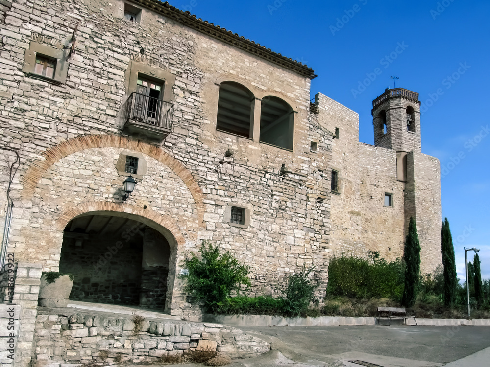 Spain, Montfalco Murallat - October 10, 2018: Arched entrance to Montfalco Murallat mediaeval village-fortress (Lleida), outside view. Tourist place in Catalonia with ancient stone walls and a chapel