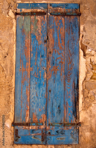 A colourful wooden shuttered window on a building in Provence France