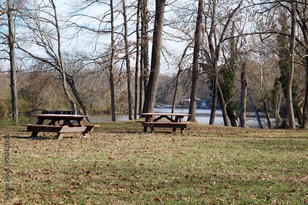 The empty picnic tables in the country park.