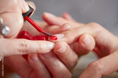 Applying manicure at nail salon 