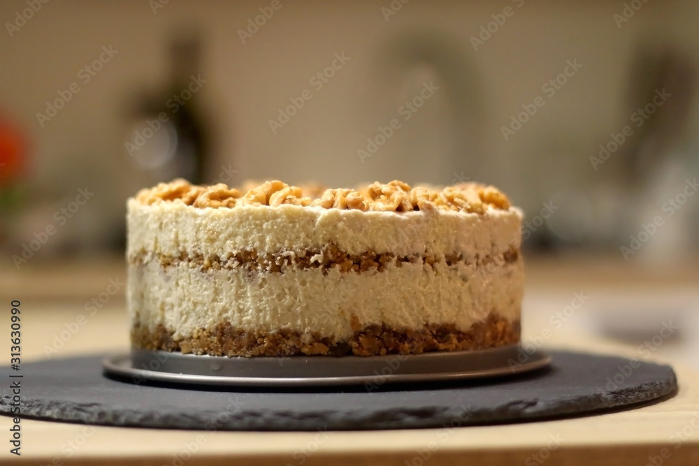 Vegan cake with walnuts, cashew nuts and raisins. Selective focus. Vegan cake with walnuts, cashew nuts and raisins. Selective focus.