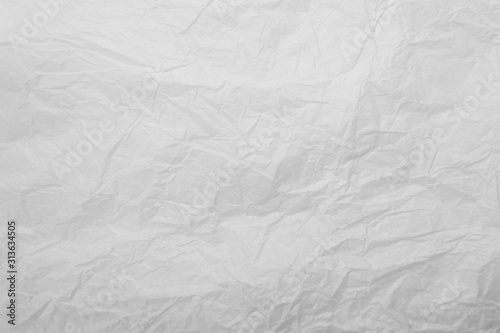 White crumpled creased paper sheet texture background. Old and dilapidated paper with kinks and dents