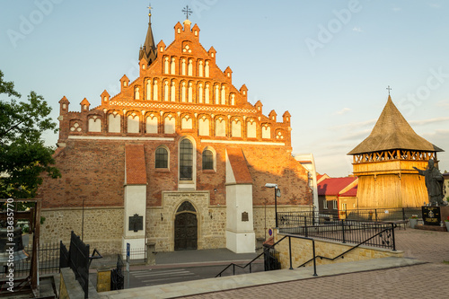 Collegiate Basilica of St. Nicholas, along with a wooden belfry and parish buildings in the city of Bochnia, Poland photo