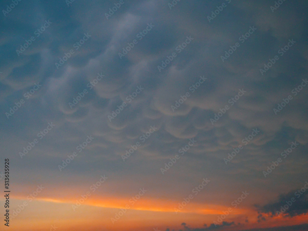 Fototapeta premium Picturesque view of a puffy blanket of clouds covering the sunny morning sky.