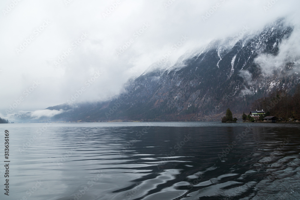 Fototapeta premium Winter lake surrounded by snow mountains of hallstatt in Austria.