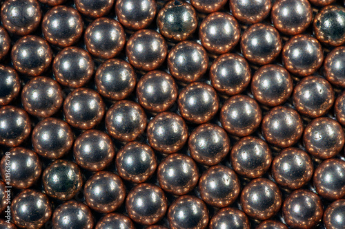 Macro Copper and steel ball bearings in repeating pattern 2