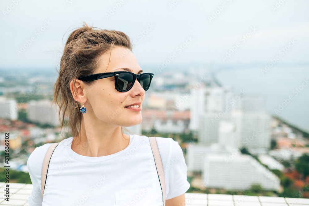 Trendy girl posing in the street background Trendy girl posing in the street background