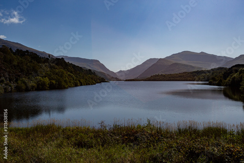 View along Llyn Padarn lake looking towards Snowdonia mountain range, North Wales